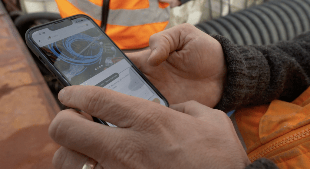 construction worker using mobile mutu app to manage and reuse materials on site